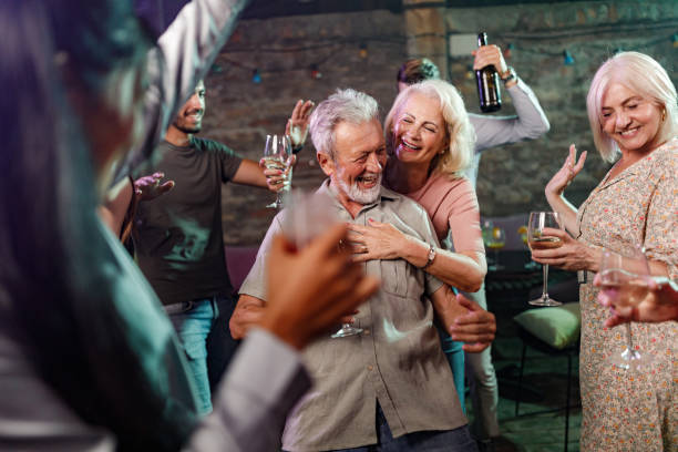 istock Carefree seniors having fun among young people in a disco. 1407062385