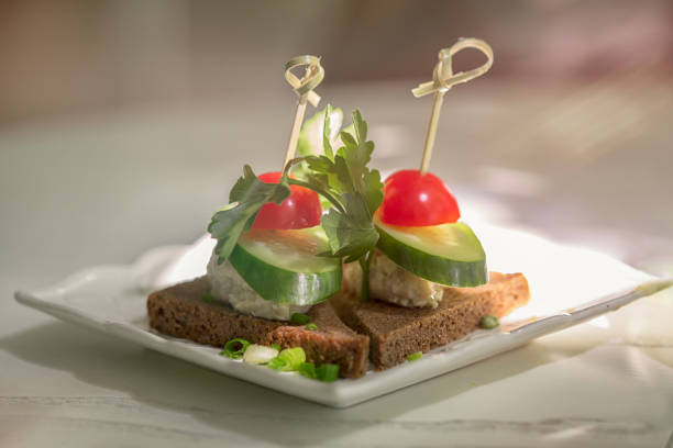 istock Toasts with black bread, cucumber and tomatoes 1407062575
