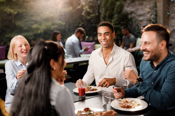 istock Happy business colleagues having lunch in a restaurant. 1407062848