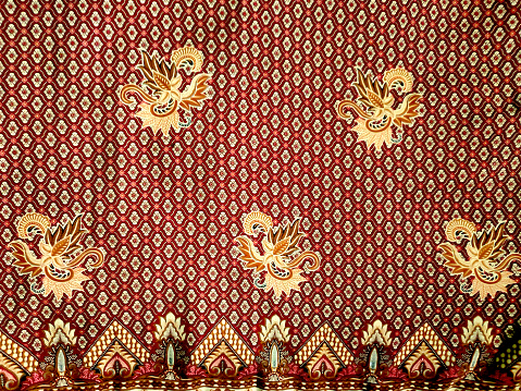 Shot of traditional pattern batik.  Batik is a technique of wax-resist dyeing applied to the whole cloth. This technique originated from the island of Java, Indonesia