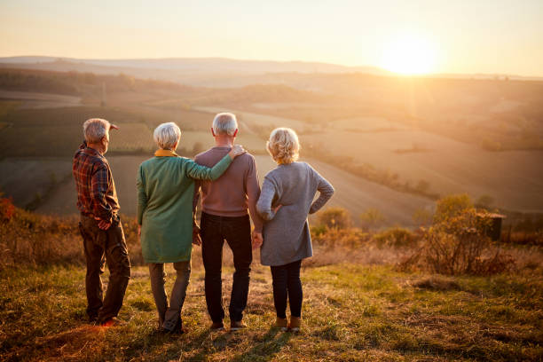 istock Back view of seniors looking at sunset view from a hill. 1407064001