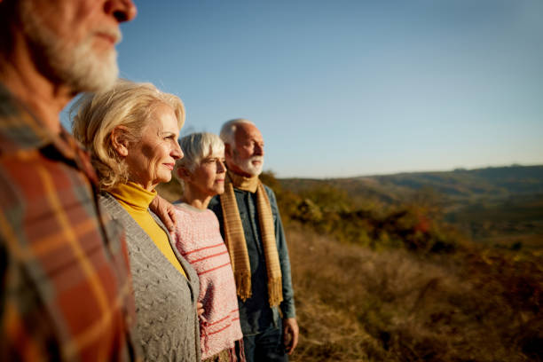 istock Mature friends looking at view from a hill. 1407064152