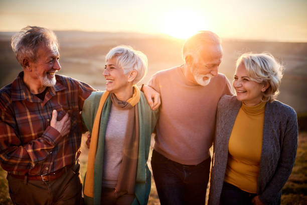 istock Happy mature couples talking while walking in autumn day. 1407064261