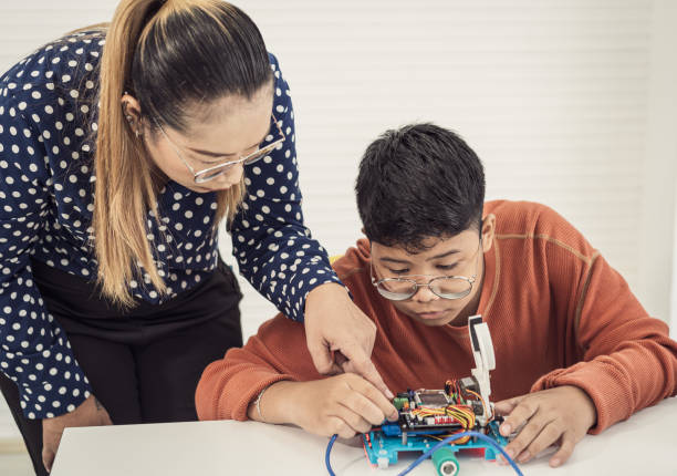 istock Students and friends learning Robotics technology in classroom with teacher 1407066467