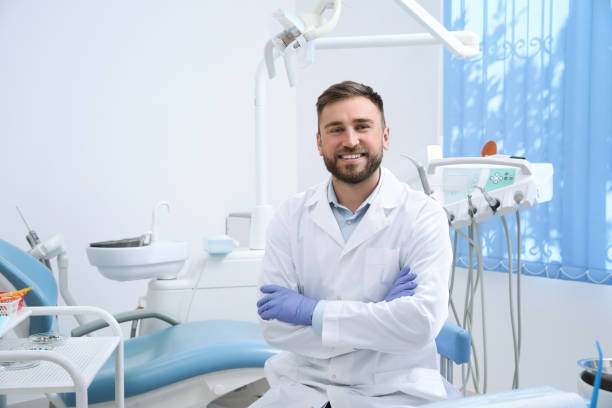 Portrait of professional dentist at workplace in clinic stock photo
