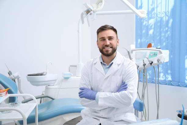 portrait of professional dentist at workplace in clinic - dentist imagens e fotografias de stock