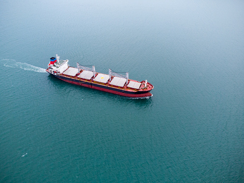 Aerial view of Cargo Ship Vessel in transit. Freight ship approaching to port. import export logistic and export products worldwide