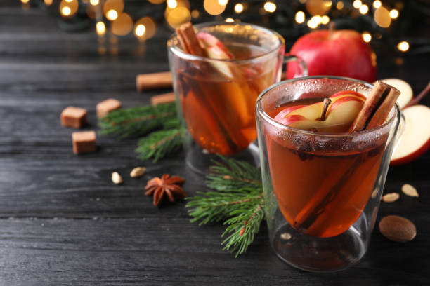 istock Aromatic hot mulled cider on black wooden table. Space for text 1407067065