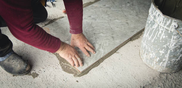 istock Laying floor ceramic tile. Renovating the floor 1407067674