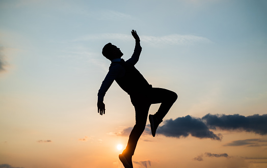 to be free. free man dancing. happiness. need the inspiration. man feel motivation. full of energy. dancer silhouette on sky background. confidence and success. concept of future.