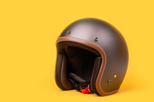 istock Close up new grey vintage helmet. Studio shot isolated on yellow 1407068998