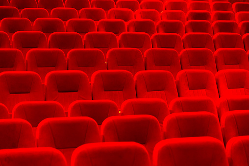 Empty cinema hall with red seats. Movie theatre