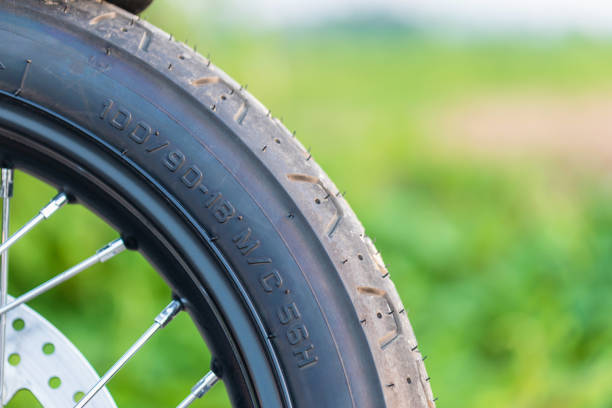 istock Number code on the front motorcycle rubber wheel. Outdoor shooting on the road with copy space 1407070544