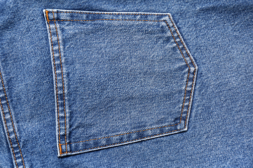 Pocket with rivets of blue denim jeans