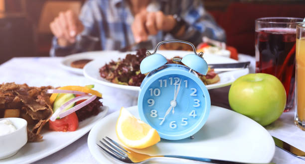 istock Selective focus of blue clock for Intermittent fasting icon, IF, fat burn, growth hormone-diet concept 1407071757