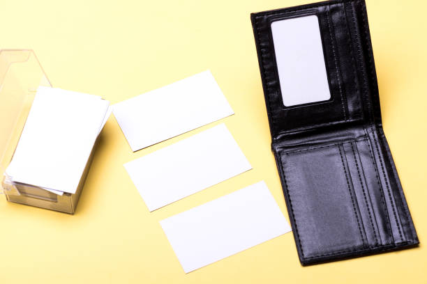istock Business cards stack in card holder on yellow background 1407071984