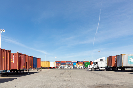 Oakland, USA - May 18, 2022: container at Oakland harbor in panoramic view. Oakland harbor serves San Francisco with goods.