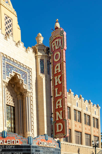 The morning sun rises on the iconic Fox Oakland Theatre, a concert hall and former movie theater in Downtown Oakland. Oakland, USA - May 19, 2022: The morning sun rises on the iconic Fox Oakland Theatre, a concert hall and former movie theater in Downtown Oakland. real estate outdoors vertical usa stock pictures, royalty-free photos & images