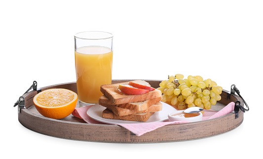Wooden tray with delicious breakfast on white background