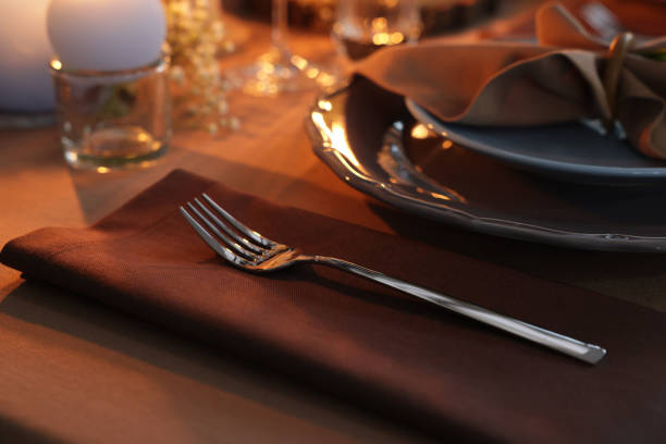 istock Beautiful setting with cutlery and plates on table 1407073800