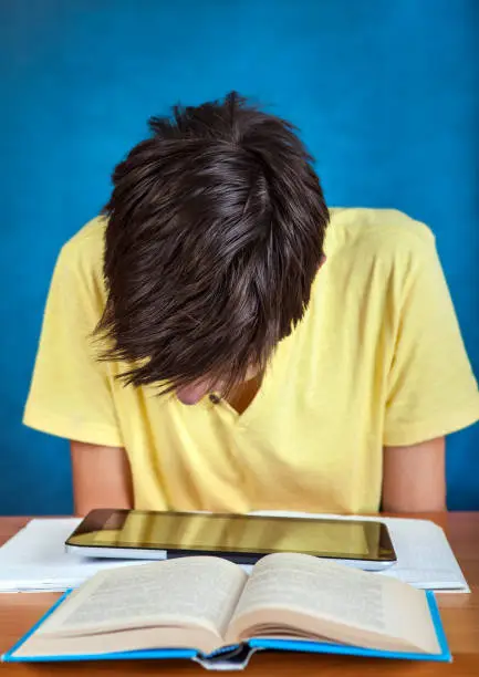 Student with the Books and Tablet Computer