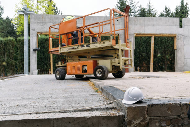 istock Scissor Lift Platform on a construction site near the wall 1407076991