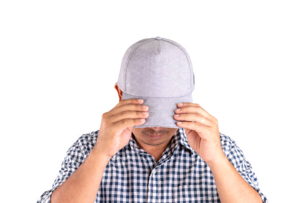 istock Close up man wearing grey cap and hide his face from camera isolated on white 1407077477