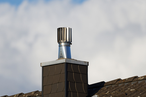 Stainless Steel Rotating Chimney Cowl on a chimney clad with slate tiles