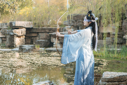Chinese beauty archery by the lake