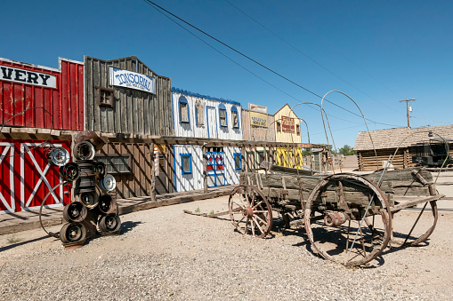 Seligman, USA - May 26, 2022: old historic wild west facade with livery and tonsorial of Doc Holliday under clear blue sky in Seligman.