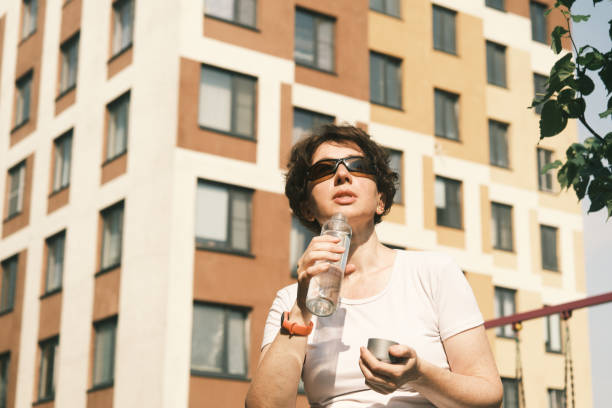 istock Woman is drinking water in city 1407080514