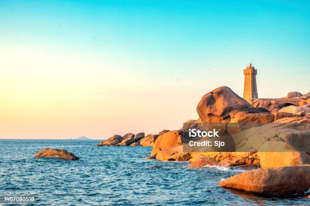 Ploumanach Lighthouse At The Pink Granite Coast In Brittany France During Sunset Stock Photo - Download Image Now