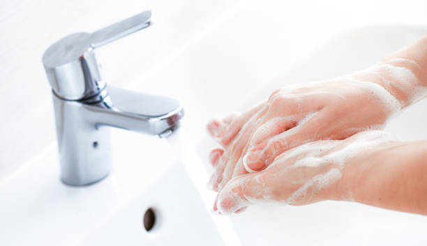 istock Washing hands under the faucet with water and soap. 1407081635