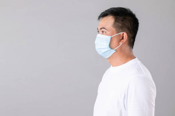 istock Thai man wearing protective face mask to prevent virus studio shot on grey background 1407082273