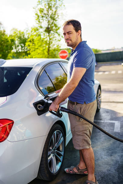 istock Young man refueling with high prices due to global inflation. 1407083145