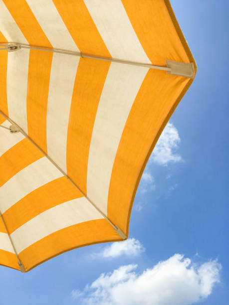 istock Yellow umbrella on the beach 1407084133