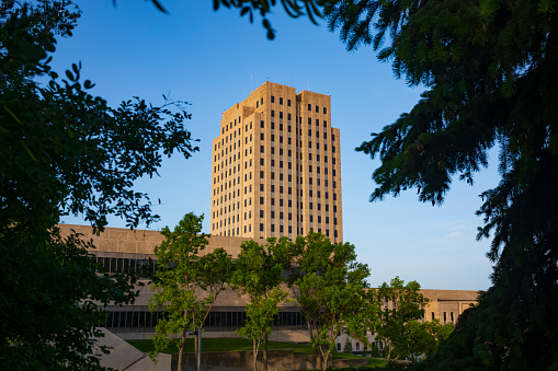 The North Dakota State Capitol, pictured here from the Capitol Grounds Native Prairie at Bismarck, is a 21-story Art Deco tower that is the tallest habitable building in the state.