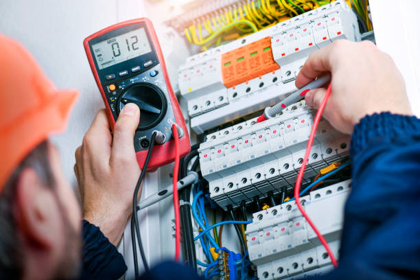 istock Electrician installing electric cable wires and fuse switch box. 1407084418