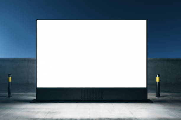 istock Outdoor advertising concept with front view on blank white illuminated billboard with place for your logo or text on night city street background. 3D rendering, mockup 1407084581