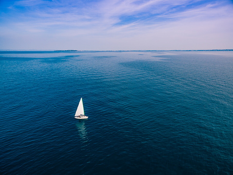 High angle view of solitary sailboat.