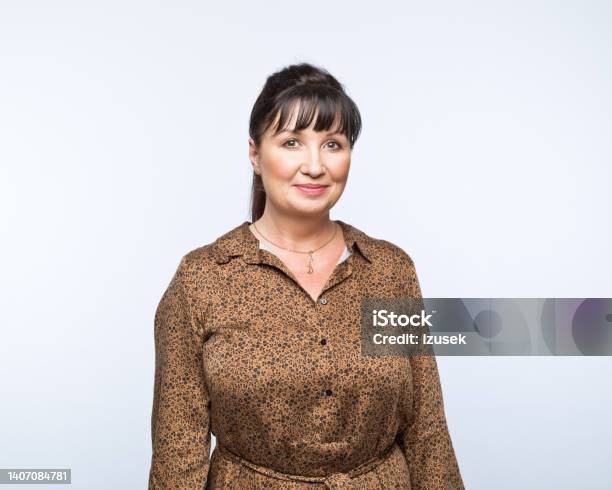 Portrait Of Smiling Mature Women Stock Photo - Download Image Now - 50-59 Years, Brown Hair, One Woman Only