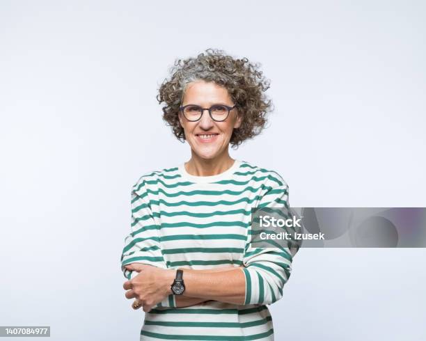 Portrait Of Smiling Mature Women Stock Photo - Download Image Now - Arms Crossed, Business, Gray Hair