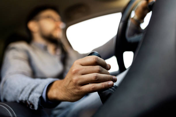 istock Businessman driving a car holding gearshift stick 1407085713