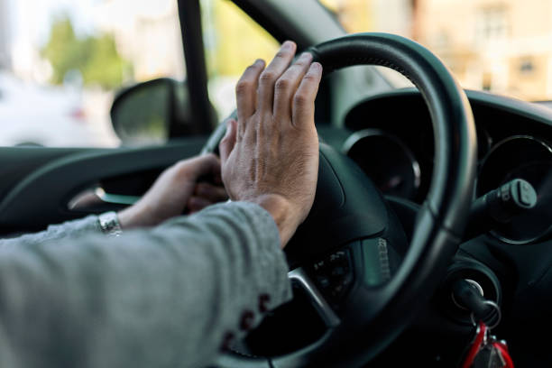 istock Unrecognizable businessman driving a car hitting car horn 1407085716