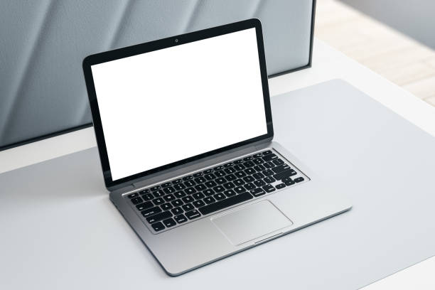 istock Top side view on modern laptop with blank white screen with place for your logo or text on light grey table surface. 3D rendering, mock up 1407087471