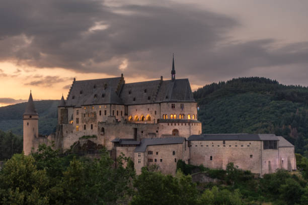 Sunset over the Castle of Vianden, Luxembourg Sunset over the medieval castle of Viandel, Luxembourg vianden stock pictures, royalty-free photos & images