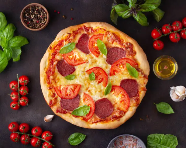 Photo of Pizza with salami, top view