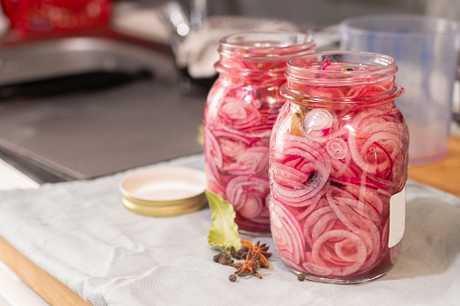 Jars of sliced onions in brine ready for sterilization