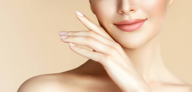 Elegant gesture of woman hand. Close up detail. Tender smile on woman lips. Beauty and cosmetology. stock photo