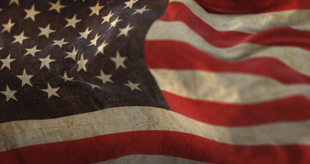 istock Old United States Flag waving at wind 1407093515